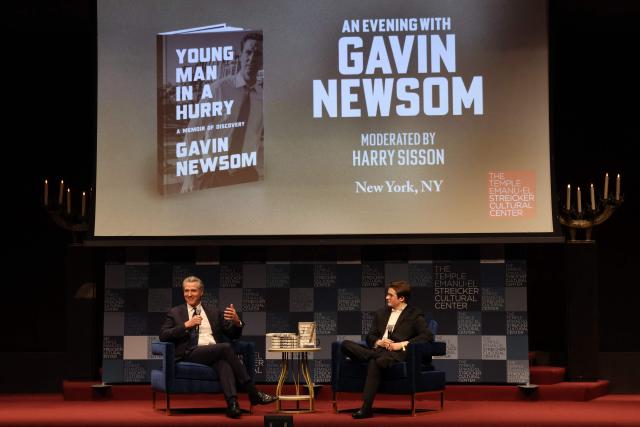 California Governor Gavin Newsom speaks with Harry Sisson to promote his book, "Young Man in a Hurry" at the Streicker Cultural Center, in New York, on February 24, 2026. (Photo by TIMOTHY A. CLARY / AFP)