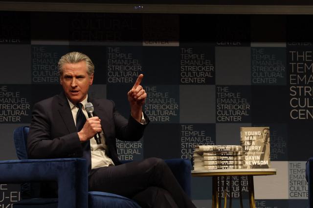California Governor Gavin Newsom speaks with Harry Sisson to promote his book, "Young Man in a Hurry" at the Streicker Cultural Center, in New York, on February 24, 2026. (Photo by TIMOTHY A. CLARY / AFP)
