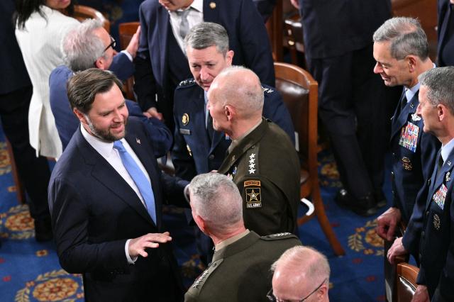 (L/R) US Vice President JD Vance and Chairman of the Joint Chiefs of Staff Dan Caine arrive for US President Donald Trump's State of the Union address in the House Chamber of the US Capitol in Washington, DC, on February 24, 2026. (Photo by Mandel NGAN / AFP)