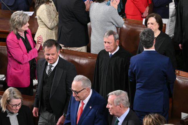 Supreme Court Chief Justice John Roberts (C) and Supreme Court Justice Elena Kagan (R) arrive for US President Donald Trump's State of the Union address in the House Chamber of the US Capitol in Washington, DC, on February 24, 2026. (Photo by Mandel NGAN / AFP)