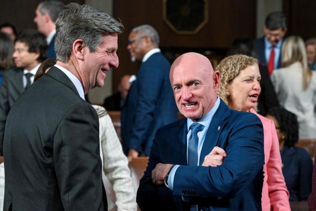 US Representative Greg Stanton (L), Democrat of Arizona, and Senator Mark Kelly, Democrat of Arizona, talk before President Donald Trump delivers the first State of the Union address of his second term to a joint session of Congress in the House Chamber of the United States Capitol in Washington, DC, on February 24, 2026. (Photo by Kenny HOLSTON / POOL / AFP)