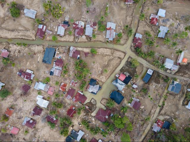 An aerial view shows flood damage to a residential area in Meurah Dua, Aceh province's Pidie Jaya district on February 22, 2026, after devastating floods and landslides struck Indonesia's Sumatra late last year. Some 32,000 flood survivors remain displaced following the late 2025 monsoon deluge. In hardest-hit Aceh province, which accounted for most of the more than 1,000 deaths, families have become increasingly frustrated over authorities' sluggish response. Many remain crammed in temporary shelters or a cluster of tents, with little expectation of returning to their mud-caked homes any time soon. (Photo by CHAIDEER MAHYUDDIN / AFP) / To go with AFP story Indonesia-flood by Alfath Asmunda