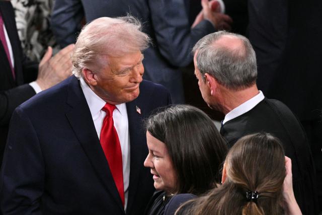 US President Donald Trump greets Supreme Court Chief Justice John Roberts as Trump arrives to deliver his State of the Union address in the House Chamber of the US Capitol in Washington, DC, on February 24, 2026. (Photo by Mandel NGAN / AFP)