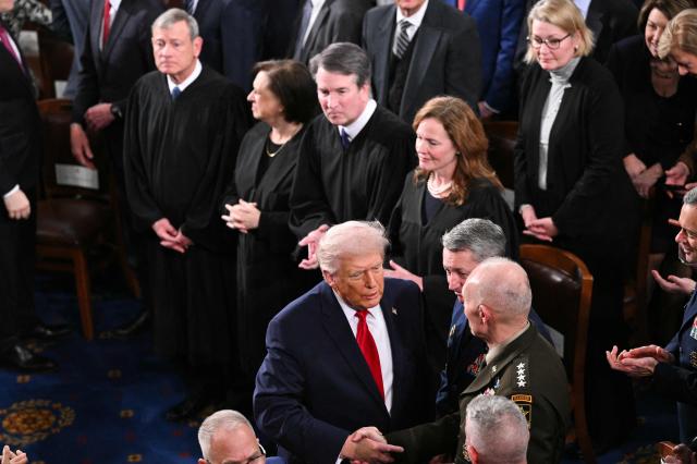 (L/R) US Supreme Court Chief Justice John Roberts, Supreme Court Justice Elena Kagan, Supreme Court Justice Brett Kavanaugh, and Supreme Court Justice Amy Coney Barrett look on as US President Donald Trump delivers the State of the Union address in the House Chamber of the US Capitol in Washington, DC, on February 24, 2026. (Photo by Mandel NGAN / AFP)