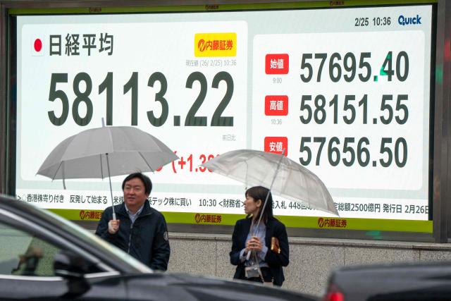 An electronic quotation board displays numbers of the Nikkei Stock Average on the Tokyo Stock Exchange along a street in Tokyo on February 25, 2026. (Photo by Kazuhiro NOGI / AFP)