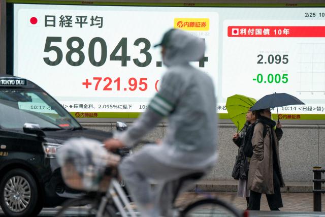 An electronic quotation board displays numbers of the Nikkei Stock Average on the Tokyo Stock Exchange along a street in Tokyo on February 25, 2026. (Photo by Kazuhiro NOGI / AFP)