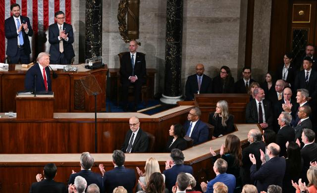 Members of Congress applaud as US President Donald Trump arrives to deliver the State of the Union address in the House Chamber of the US Capitol in Washington, DC, on February 24, 2026. (Photo by Brendan SMIALOWSKI / AFP)