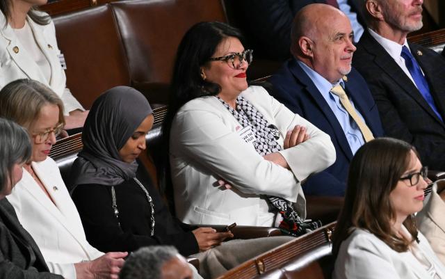 US Representatives Ilhan Omar, Democrat from Minnesota, and Rashida Tlaib, Democrat from Michigan, look on as President Donald Trump delivers the State of the Union address in the House Chamber of the US Capitol in Washington, DC, on February 24, 2026. (Photo by Brendan SMIALOWSKI / AFP)