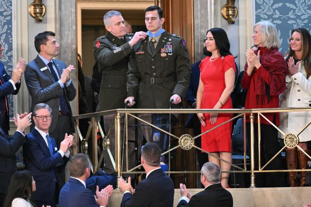 Chief Warrant Officer Eric Slover, who was wounded in the Nicolas Maduro abduction raid in Venezuela, receives the Congressional Medal of Honor during the State of the Union address in the House Chamber of the US Capitol in Washington, DC, on February 24, 2026. (Photo by Mandel NGAN / AFP)