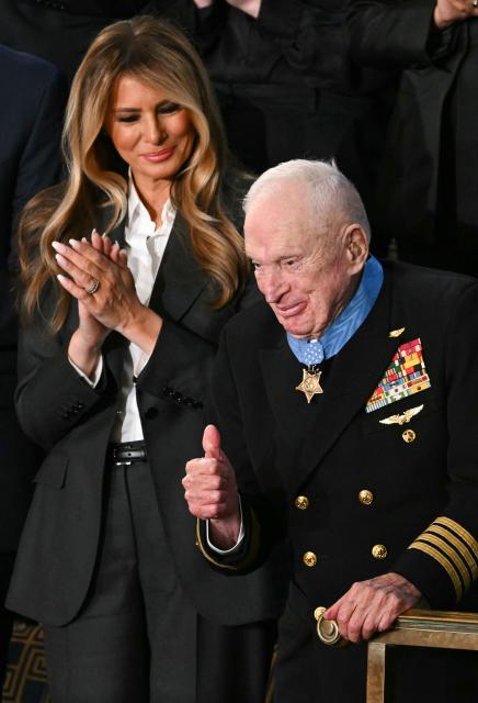 US First Lady Melania Trump presents US veteran Captain E. Royce Williams with the Medal of Honor during US President Donald Trump's the State of the Union address in the House Chamber of the US Capitol in Washington, DC, on February 24, 2026. (Photo by Brendan SMIALOWSKI / AFP)