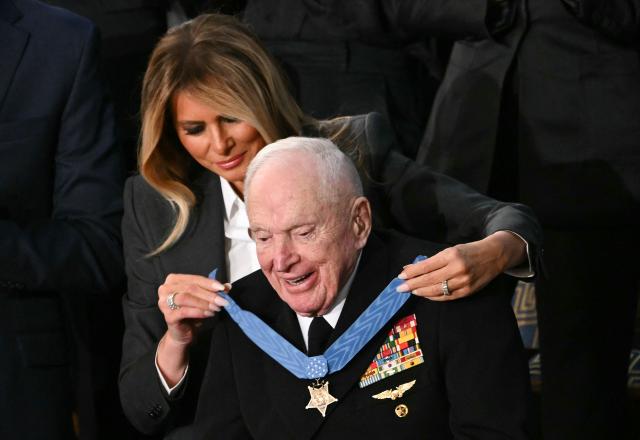 US First Lady Melania Trump presents US veteran Captain E. Royce Williams with the Medal of Honor during US President Donald Trump's the State of the Union address in the House Chamber of the US Capitol in Washington, DC, on February 24, 2026. (Photo by Brendan SMIALOWSKI / AFP)