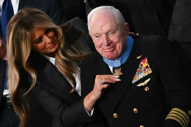 US First Lady Melania Trump presents US veteran Captain E. Royce Williams with the Medal of Honor during US President Donald Trump's the State of the Union address in the House Chamber of the US Capitol in Washington, DC, on February 24, 2026. (Photo by ANDREW CABALLERO-REYNOLDS / AFP)