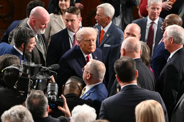 US President Donald Trump shakes hands with members of Congress as he departs following his State of the Union address in the House Chamber of the US Capitol in Washington, DC, on February 24, 2026. (Photo by ANDREW CABALLERO-REYNOLDS / AFP)