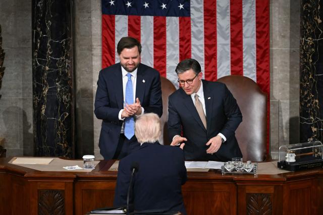 US President Donald Trump shakes hands with US Vice President JD Vance (L) and US Speaker of the House Mike Johnson (R) as he concludes his remarks during the State of the Union address in the House Chamber of the US Capitol in Washington, DC, on February 24, 2026. (Photo by ANDREW CABALLERO-REYNOLDS / AFP)