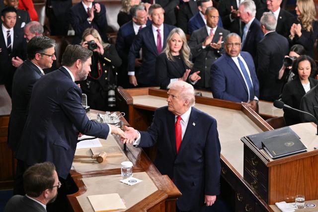 US President Donald Trump shakes hands with US Vice President JD Vance as he concludes his remarks during the State of the Union address in the House Chamber of the US Capitol in Washington, DC, on February 24, 2026. (Photo by Mandel NGAN / AFP)