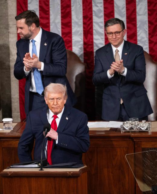 US President Donald Trump adjusts his suit as he concludes his remarks during the State of the Union address at the US Capitol in Washington, February 24, 2026. (Photo by ANDREW CABALLERO-REYNOLDS / AFP)