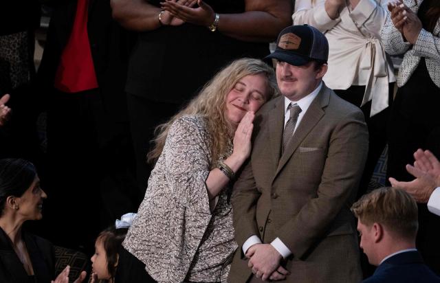 National Guard Staff Sgt. Andrew Wolfe, who survived a November 2025 shooting attack in Washington, DC, receives a Purple Heart as he is recognized by US President Donald Trump during his State of the Union address in the House Chamber of the US Capitol in Washington, DC, on February 24, 2026. (Photo by Brendan Smialowski / AFP)