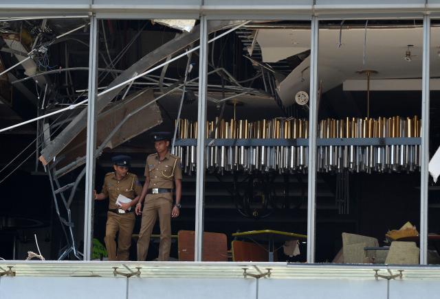 (FILES) Sri Lankan police stand at the site of an explosion in a restaurant area of the luxury Shangri-La Hotel in Colombo on April 21, 2019. Sri Lanka's criminal investigators arrested the country's former intelligence chief Suresh Sallay on February 25 in connection with the 2019 Easter Sunday bombings that killed 279 people, police said. (Photo by ISHARA S. KODIKARA / AFP)