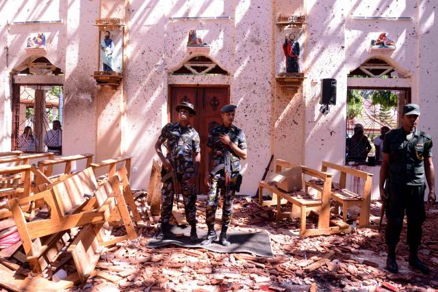 (FILES) Sri Lankan soldiers look on inside the St Sebastian's Church at Katuwapitiya in Negombo on April 21, 2019, following a bomb blast during the Easter service that killed tens of people. Sri Lanka's criminal investigators arrested the country's former intelligence chief Suresh Sallay on February 25 in connection with the 2019 Easter Sunday bombings that killed 279 people, police said. (Photo by AFP)