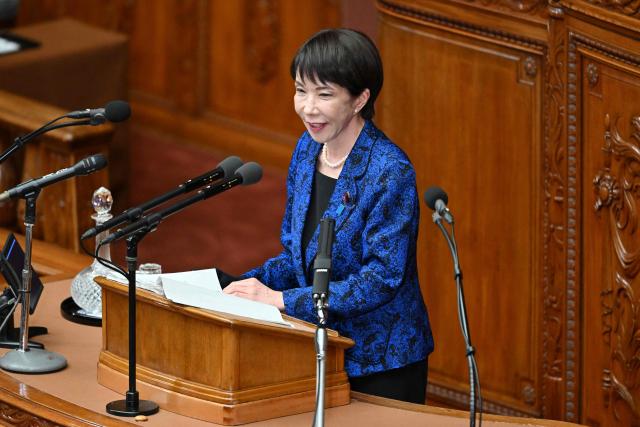 Japan's Prime Minister Sanae Takaichi answers questions from Yuichiro Tamaki, head of the Democratic Party for the People, during a plenary session of the House of Representatives in Tokyo on February 25, 2026. (Photo by Kazuhiro NOGI / AFP)