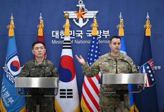 Colonel Jang Do-young (L), public affairs director of South Korea's Joint Chiefs of Staff, and Colonel Ryan Donald (R), public affairs director of the United Nations Command (UNC), Combined Forces Command (CFC) and United States Forces Korea (USFK), attend a press briefing on the 2026 ROK-US Freedom Shield Military Exercise at the Defence Ministry in Seoul on February 25, 2026. (Photo by JUNG YEON-JE / POOL / AFP)