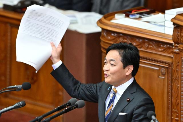 Japan's opposition Democratic Party for the People leader Yuichiro Tamaki asks questions to Prime Minister Sanae Takaichi during a plenary session of the House of Representatives in Tokyo on February 25, 2026. (Photo by Kazuhiro NOGI / AFP)