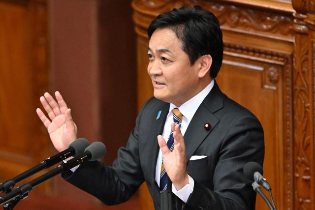Japan's opposition Democratic Party for the People leader Yuichiro Tamaki asks questions to Prime Minister Sanae Takaichi during a plenary session of the House of Representatives in Tokyo on February 25, 2026. (Photo by Kazuhiro NOGI / AFP)