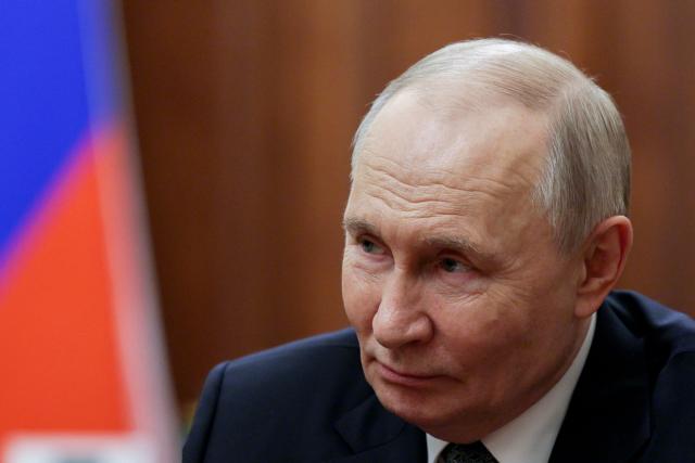 In this pool photograph distributed by the Russian state agency Sputnik, Russia's President Vladimir Putin attends a meeting with General Director of the Bolshoi Theatre in Moscow on February 25, 2026.  (Photo by Gavriil GRIGOROV / POOL / AFP)