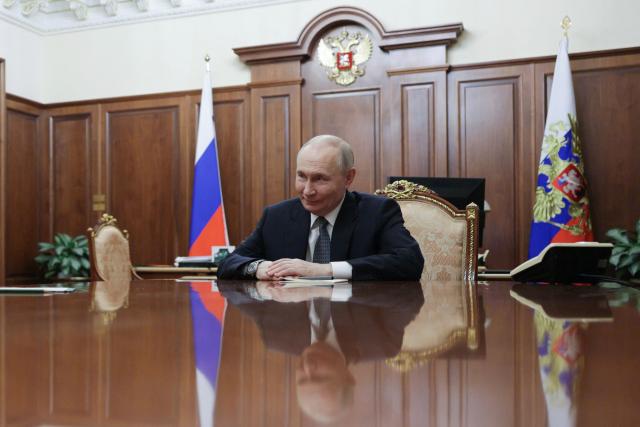 In this pool photograph distributed by the Russian state agency Sputnik, Russia's President Vladimir Putin attends a meeting with General Director of the Bolshoi Theatre in Moscow on February 25, 2026.  (Photo by Gavriil GRIGOROV / POOL / AFP)