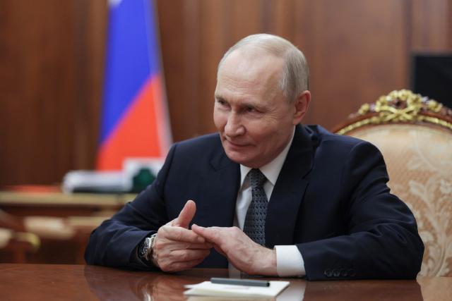 In this pool photograph distributed by the Russian state agency Sputnik, Russia's President Vladimir Putin attends a meeting with General Director of the Bolshoi Theatre in Moscow on February 25, 2026.  (Photo by Gavriil GRIGOROV / POOL / AFP)