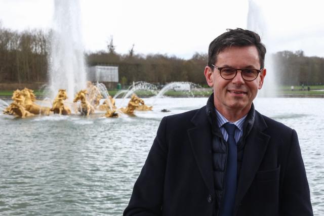 (FILES) Head of the Chateau de Versailles domain, Christophe Leribault, poses for photographs in front of the "Bassin d'Apollon" fountain (The Apollo Basin), on the sidelines of a media tour of the Paris 2024 Olympic and Paralympic venue infrastructure in Versailles, southwest of Paris, on March 29, 2024. The current president of the Palace of Versailles, Christophe Leribault, is tipped to take over the Louvre after the resignation of Laurence des Cars, a source within the executive told AFP on February 25, 2026, confirming a report by Le Parisien. (Photo by Emmanuel Dunand / AFP)