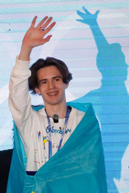 Kazakhstan's Olympic gold medallist Mikhail Shaidorov gestures during an official welcoming ceremony to mark his arrival from the Milano Cortina 2026 Winter Olympic Games at the airport in Astana on February 25, 2026. (Photo by Stanislav Filippov / AFP)
