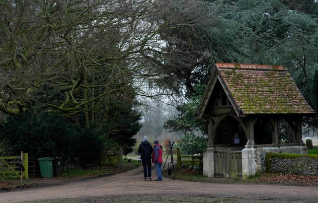 Members of the media stand at an entrance to Wood Farm on the royal family's Sandringham Estate in Norfolk, eastern England on February 25, 2026, after Britain's former prince Andrew was arrested on February 19. (Photo by CARLOS JASSO / AFP)