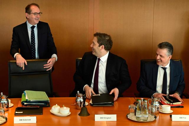 German Finance Minister and Vice Chancellor Lars Klingbeil (C) greets German Interior Minister Alexander Dobrindt (L) as he sits next to Chief of Staff and Minister for Special Tasks Thorsten Frei at the start of the weekly cabinet meeting on February 25, 2026 at the Chancellery in Berlin. (Photo by John MACDOUGALL / AFP)