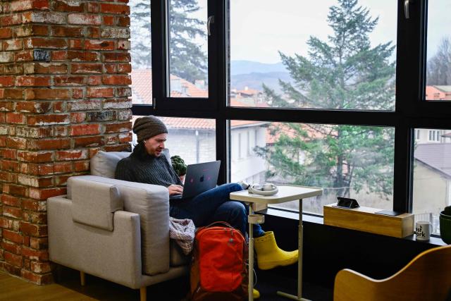 French software engineer Fabian Aussems works in a co-working centre in Bansko on February 13, 2026. Bulgaria's largest ski resort of Bansko in Pirin mountain is becoming a hub for digital nomads, copywriters, enterpreneurs and retirees from around the world. (Photo by Nikolay DOYCHINOV / AFP) / TO GO WITH AFP STORY BY ROSSEN BOSSEV