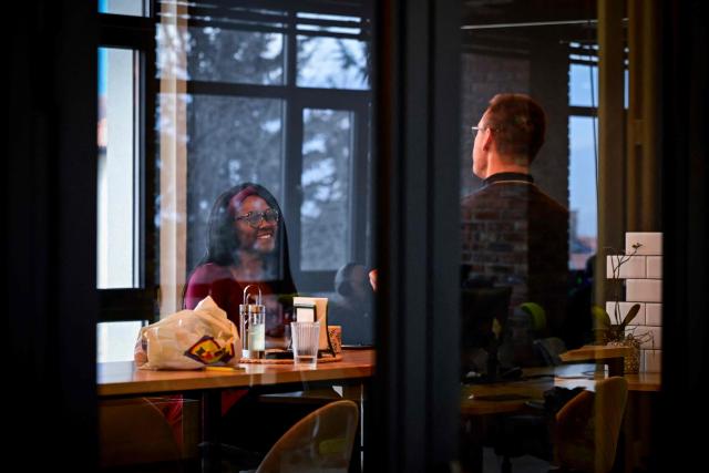 People chat in a co-working centre in Bansko on February 13, 2026. Bulgaria's largest ski resort of Bansko in Pirin mountain is becoming a hub for digital nomads, copywriters, enterpreneurs and retirees from around the world. (Photo by Nikolay DOYCHINOV / AFP) / TO GO WITH AFP STORY BY ROSSEN BOSSEV