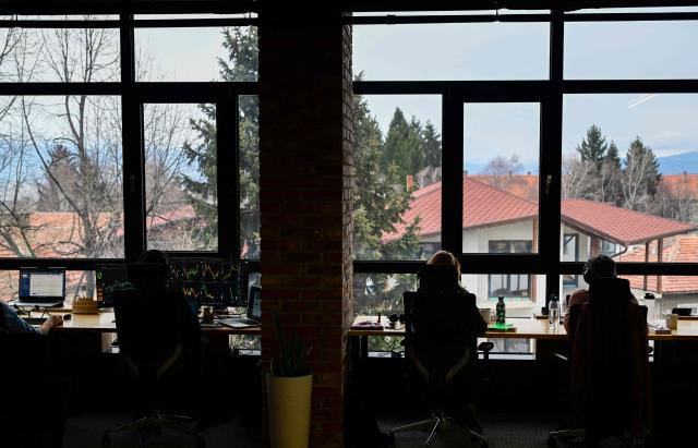 People work in a co-working centre in Bansko on February 13, 2026. Bulgaria's largest ski resort of Bansko in Pirin mountain is becoming a hub for digital nomads, copywriters, enterpreneurs and retirees from around the world. (Photo by Nikolay DOYCHINOV / AFP) / TO GO WITH AFP STORY BY ROSSEN BOSSEV