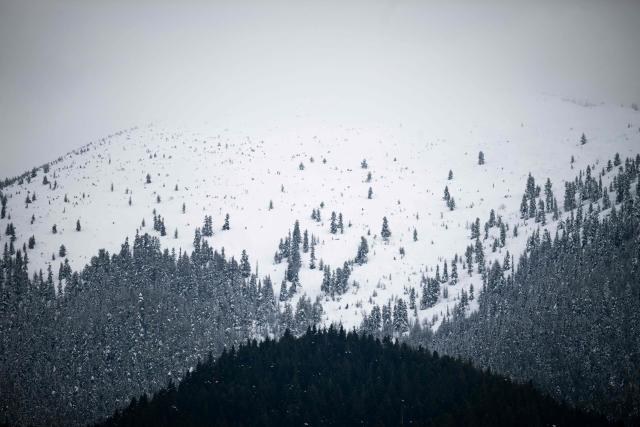 This general view shows the snow covered peak of Pirin mountain, hidden in the clouds near Bansko on February 13, 2026. Bulgaria's largest ski resort of Bansko in Pirin mountain is becoming a hub for digital nomads, copywriters, enterpreneurs and retirees from around the world. (Photo by Nikolay DOYCHINOV / AFP) / TO GO WITH AFP STORY BY ROSSEN BOSSEV