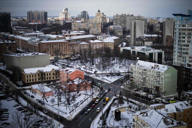 Cars drive along the street in a residential area in central Kyiv on February 19, 2026, amid the Russian invasion of Ukraine. As Ukraine accuses Russia of trying to freeze the population into submission with its most intense attacks on the energy network of the entire war, more and more people in Kyiv are fundraising and pooling cash to buy alternative sources of shared electricity. (Photo by HENRY NICHOLLS / AFP)