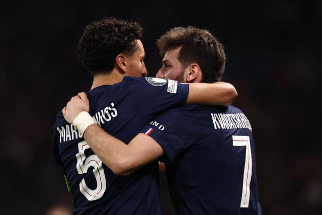 TOPSHOT - Paris Saint-Germain's Brazilian defender #05 Marquinhos (L) celebrates with Paris Saint-Germain's Georgian forward #07 Khvicha Kvaratskhelia (R) after scoring Paris Saint-Germain's first goal during the UEFA Champions League play-off second leg football match between Paris Saint-Germain (PSG) and AS Monaco at the Parc des Princes stadium in Paris on February 25, 2026. (Photo by FRANCK FIFE / AFP)