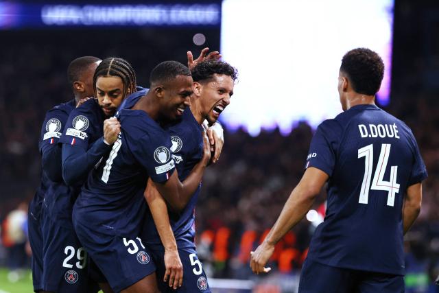 Paris Saint-Germain's Brazilian defender #05 Marquinhos (C) celebrates with teammates after scoring Paris Saint-Germain's first goal during the UEFA Champions League play-off second leg football match between Paris Saint-Germain (PSG) and AS Monaco at the Parc des Princes stadium in Paris on February 25, 2026. (Photo by FRANCK FIFE / AFP)