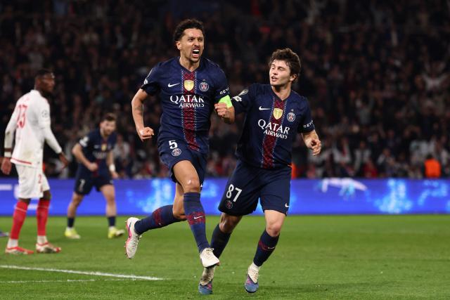 Paris Saint-Germain's Brazilian defender #05 Marquinhos (CL) celebrates with Paris Saint-Germain's Portuguese midfielder #87 Joao Neves (CR) after scoring Paris Saint-Germain's first goal during the UEFA Champions League play-off second leg football match between Paris Saint-Germain (PSG) and AS Monaco at the Parc des Princes stadium in Paris on February 25, 2026. (Photo by FRANCK FIFE / AFP)