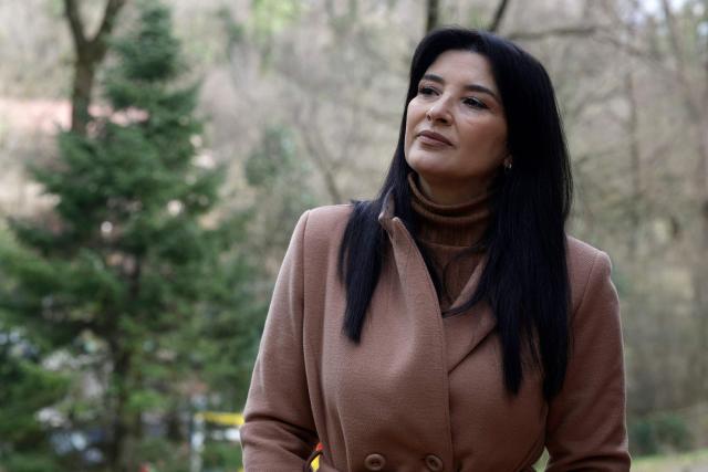 Albanian actress Anila Bisha poses during an AFP interview in Tirana on February 19, 2026 following the creation of AI-generated chatbot named "Diella", using her likeness and voice, delivered a speech in parliament without her knowledge. Over a 30-year career, Albanian actor Anila Bisha became renowned for playing complex women on the stage and screen, but now she lives in the shadow of her 'AI-generated' clone and a performance she never gave. Last September, Albania's Prime Minister Edi Rama announced, with much fanfare, the appointment of what he claimed was the first AI-generated minister, tasked with preventing corruption in public tenders. Within days, 'the minister' would deliver its inaugural parliamentary speech. (Photo by Adnan Beci / AFP)