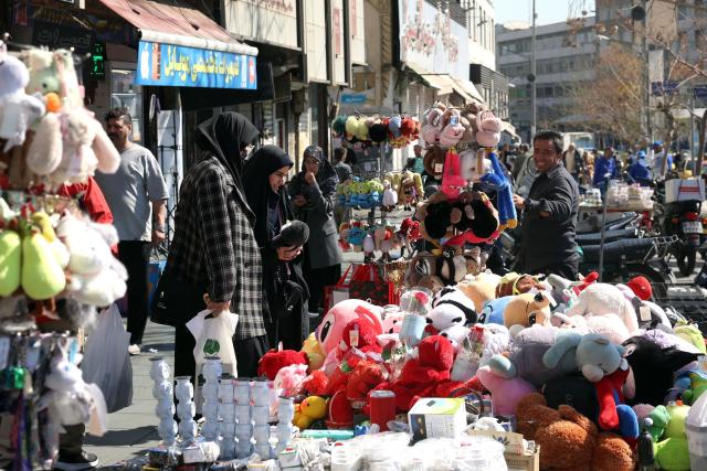 Women shop for stuffed toys at a marketplace in Tehran on February 26, 2026. A third round of indirect talks between the United States and Iran, mediated by Oman's foreign minister, opened in Geneva on February 26 morning, a diplomatic source told AFP. (Photo by AFP)