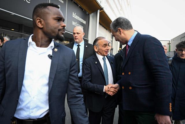 French far-right Reconquete party leader Eric Zemmour (C) shakes hands with an attendee as he arrives to visit the Paris International Agricultural Show (Salon de l'Agriculture) at Paris Expo Porte de Versailles in Paris on February 26, 2026. (Photo by Anna KURTH / AFP)