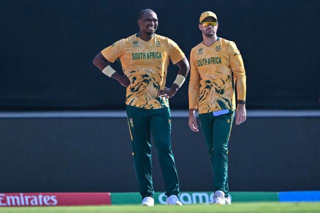South Africa's Lungi Ngidi (L) speaks with captain Aiden Markram during the 2026 ICC Men's T20 Cricket World Cup Super Eights match between West Indies and South Africa at Narendra Modi Stadium in Ahmedabad on February 26, 2026. (Photo by Indranil MUKHERJEE / AFP)
