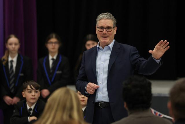 Britain's Prime Minister Keir Starmer speaks with students and staff during a visit to the Walbottle Academy Campus in suburban Newcastle-upon-Tyne, north-east England on February 26, 2026, as part of his fight to reduce the high cost of living and highlight the government’s plan to raise standards for schools. (Photo by SCOTT HEPPELL / POOL / AFP)