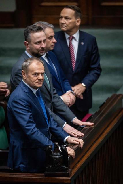 (L-R) Poland's Prime Minister Donald Tusk, Poland's Deputy Prime Minister and Minister of Defence Wladyslaw Kosiniak-Kamysz, Poland's Deputy Prime Minister and Minister of Digital Affairs Krzysztof Gawkowski and Poland's Deputy Prime Minister and Minister of Foreign Affairs Radoslaw Sikorski attend a session of the parliament, where the Minister of Foreign Afairs presented the main points of the Polish government's foreign policy, in Warsaw on February 26, 2026. (Photo by Wojtek RADWANSKI / AFP)
