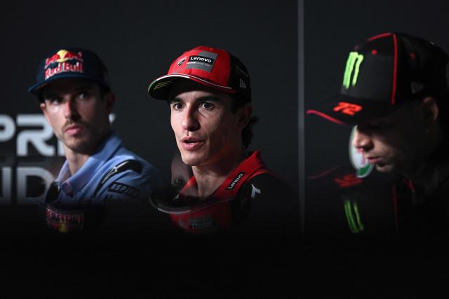 Ducati Lenovo Team's Spanish rider Marc Marquez (C) speaks as BK8 Gresini Racing's Spanish rider Alex Marquez (L) and Aprilia Racing's Italian rider Marco Bezzecchi (R) look on during a press conference at the Buriram International Circuit in Buriram on February 26, 2026, ahead of the Thailand MotoGP Grand Prix. (Photo by Lillian SUWANRUMPHA / AFP)