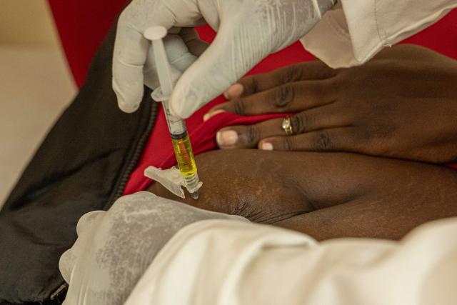 A clinician administers a dose of the long-acting injectable HIV pre-exposure prophylaxis (PrEP), Lenacapavir injection to a client, during its launch marking the first phase of the national rollout at the Riruta Health Centre in Nairobi on February 26, 2026. Kenya began administering the first dose of a groundbreaking HIV prevention drug in a Nairobi slum on Thursday.
Lenacapavir, taken twice a year, has been shown to reduce the risk of HIV transmission by more than 99.9 percent, though it is technically a chemical drug rather than a vaccine because it does not train the immune system. (Photo by SIMON MAINA / AFP)